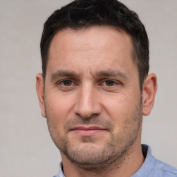 Joyful white adult male with short  brown hair and brown eyes