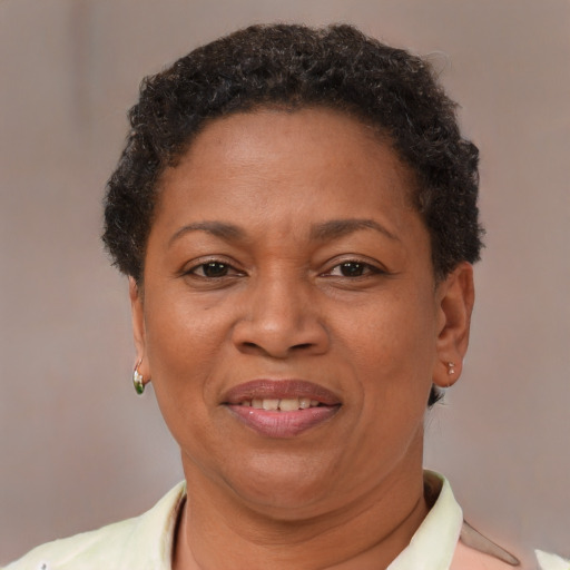 Joyful black adult female with short  brown hair and brown eyes