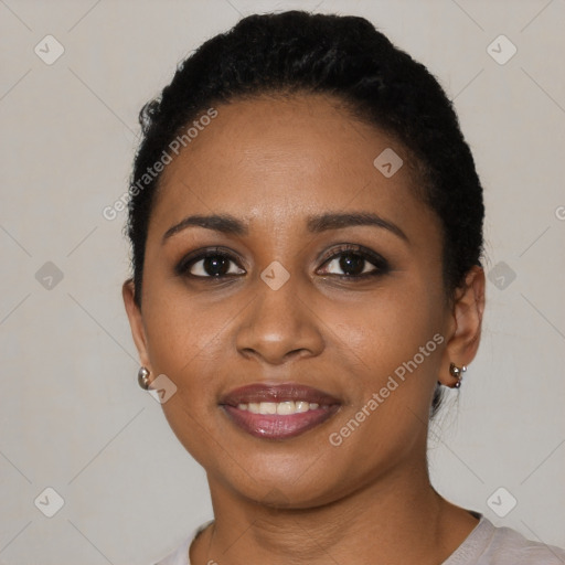 Joyful black young-adult female with short  black hair and brown eyes