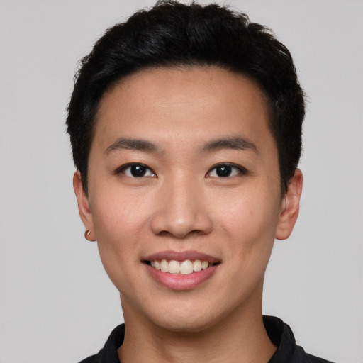 Joyful asian young-adult male with short  black hair and brown eyes