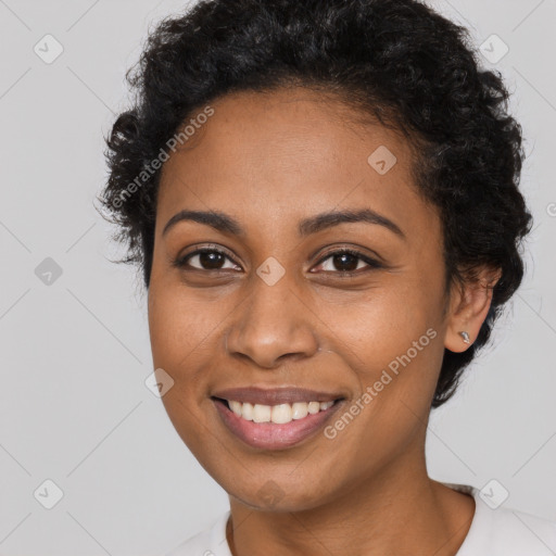 Joyful black young-adult female with short  brown hair and brown eyes