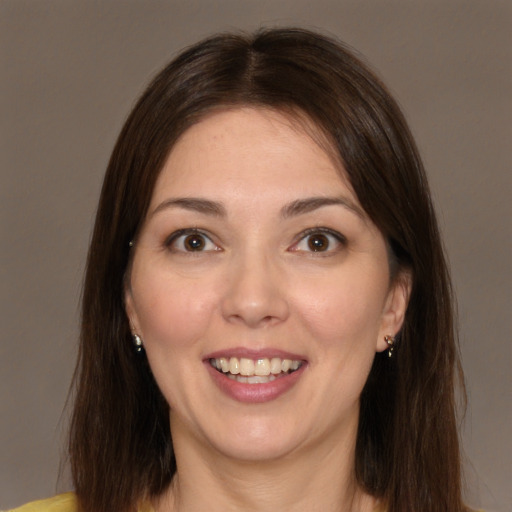 Joyful white young-adult female with medium  brown hair and brown eyes