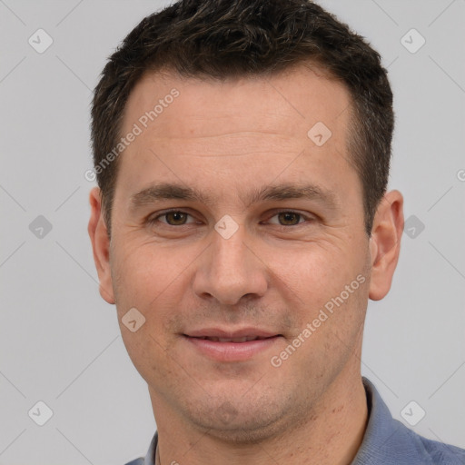 Joyful white adult male with short  brown hair and brown eyes