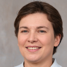 Joyful white adult female with medium  brown hair and brown eyes