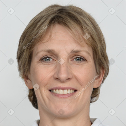 Joyful white adult female with medium  brown hair and grey eyes