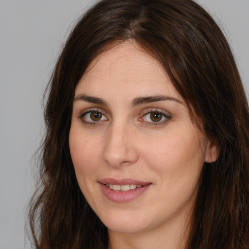 Joyful white young-adult female with long  brown hair and brown eyes