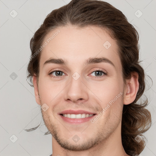 Joyful white young-adult male with medium  brown hair and brown eyes