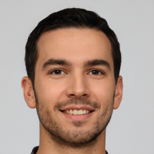 Joyful white young-adult male with short  brown hair and brown eyes