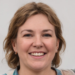 Joyful white adult female with medium  brown hair and blue eyes