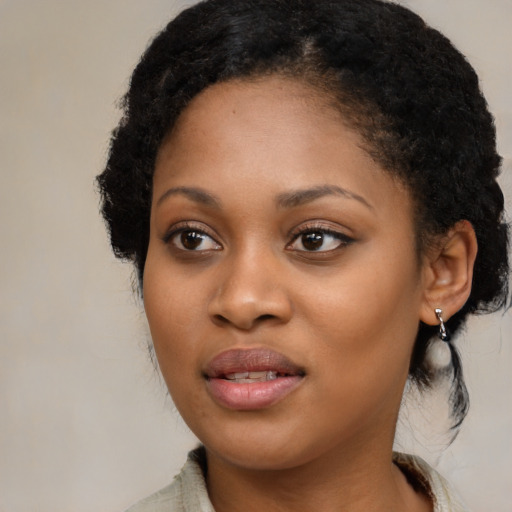 Joyful black young-adult female with medium  black hair and brown eyes
