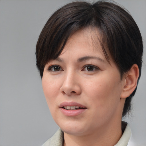 Joyful asian adult female with medium  brown hair and brown eyes