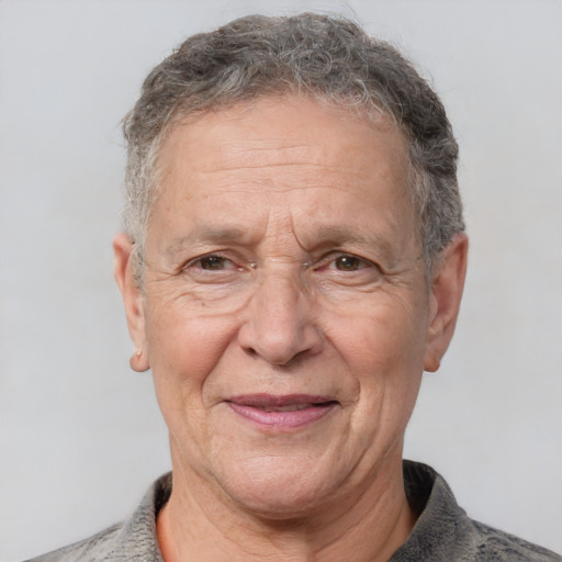 Joyful white middle-aged male with short  gray hair and brown eyes