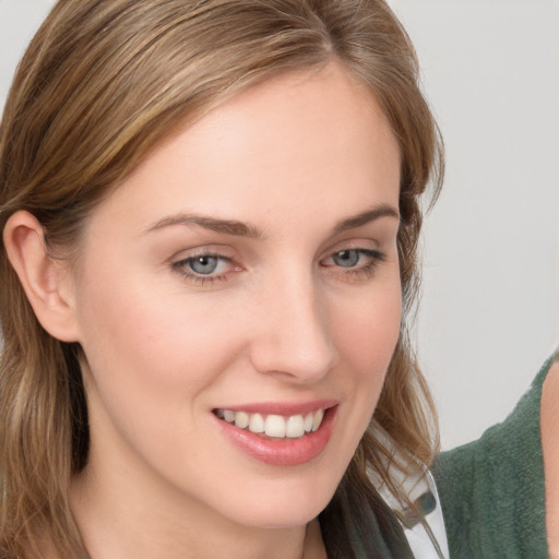 Joyful white young-adult female with medium  brown hair and blue eyes