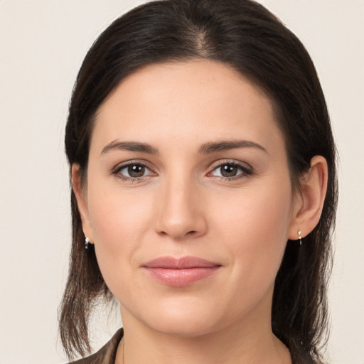 Joyful white young-adult female with medium  brown hair and brown eyes