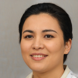 Joyful asian young-adult female with medium  brown hair and brown eyes