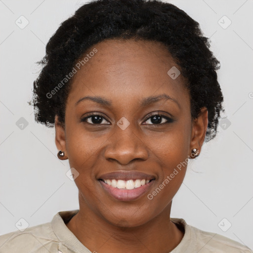 Joyful black young-adult female with short  black hair and brown eyes