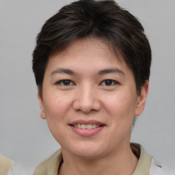 Joyful asian young-adult female with short  brown hair and brown eyes