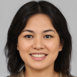 Joyful asian young-adult female with medium  brown hair and brown eyes