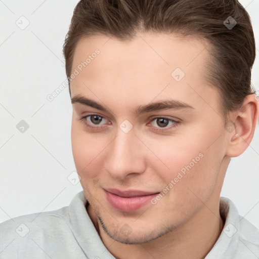 Joyful white young-adult male with short  brown hair and brown eyes