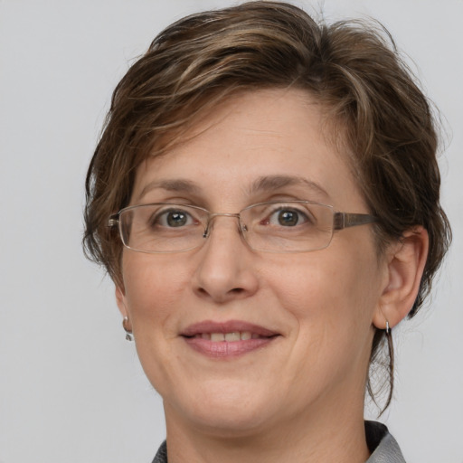 Joyful white adult female with medium  brown hair and grey eyes