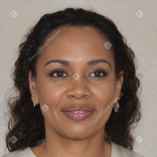 Joyful black adult female with medium  brown hair and brown eyes