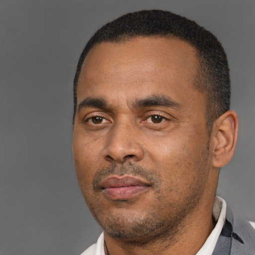 Neutral latino adult male with short  black hair and brown eyes