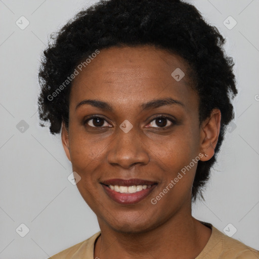 Joyful black young-adult female with short  black hair and brown eyes