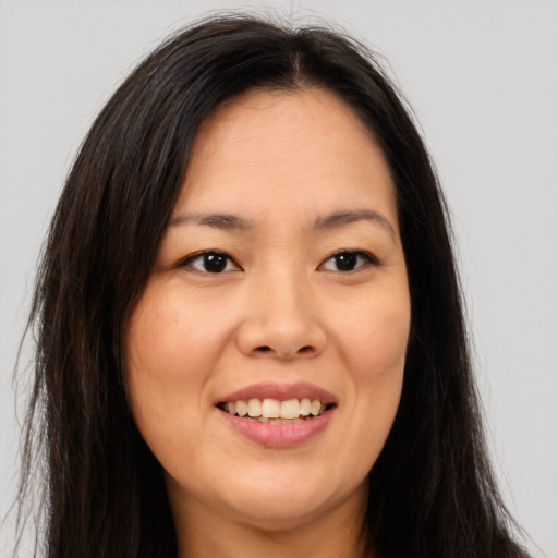 Joyful asian young-adult female with long  brown hair and brown eyes