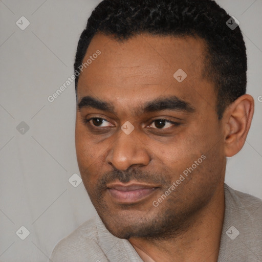 Joyful black young-adult male with short  black hair and brown eyes