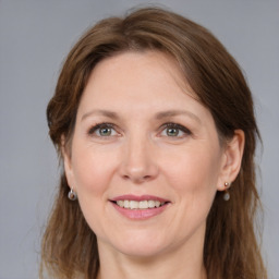 Joyful white adult female with medium  brown hair and grey eyes