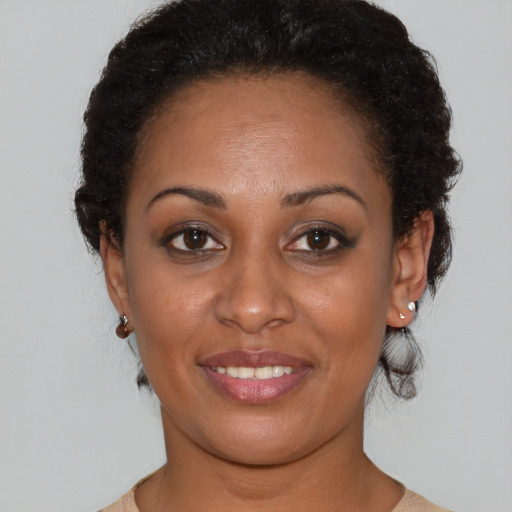 Joyful black young-adult female with medium  brown hair and brown eyes