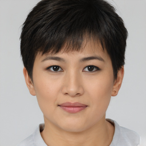 Joyful asian young-adult female with short  brown hair and brown eyes