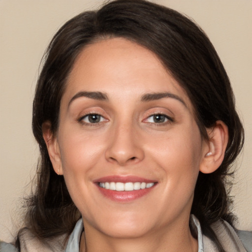 Joyful white young-adult female with medium  brown hair and brown eyes