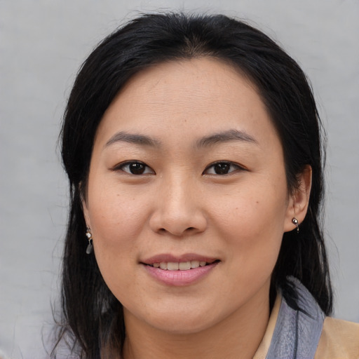 Joyful asian young-adult female with medium  brown hair and brown eyes