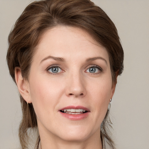 Joyful white young-adult female with medium  brown hair and grey eyes