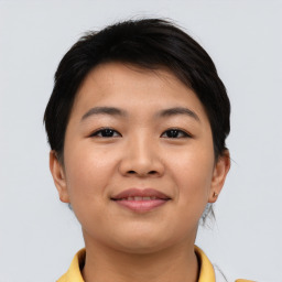 Joyful asian young-adult female with short  brown hair and brown eyes