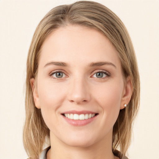 Joyful white young-adult female with long  brown hair and green eyes