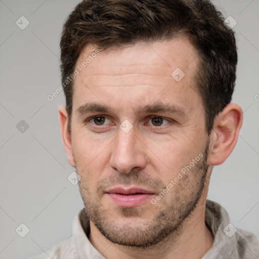 Joyful white adult male with short  brown hair and brown eyes