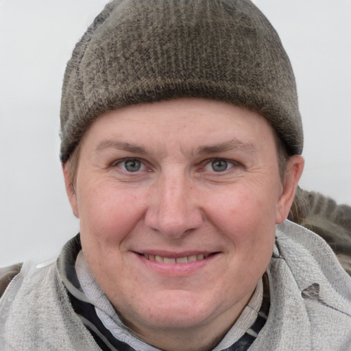 Joyful white young-adult female with short  brown hair and blue eyes