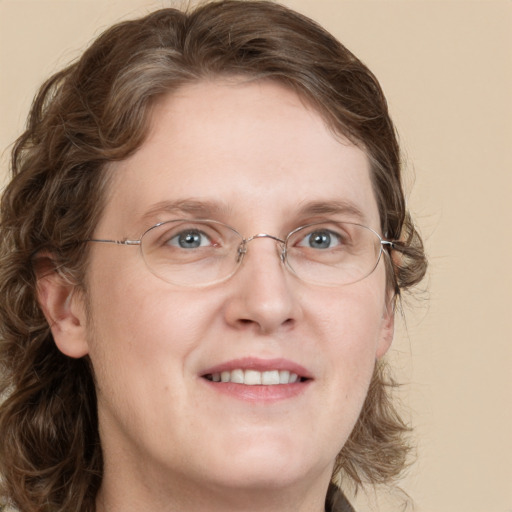 Joyful white adult female with medium  brown hair and blue eyes