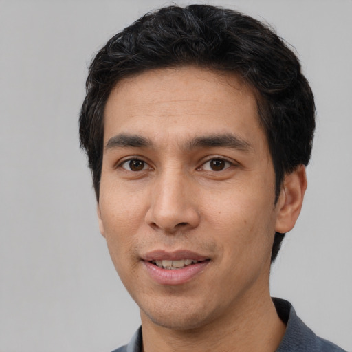 Joyful white young-adult male with short  black hair and brown eyes