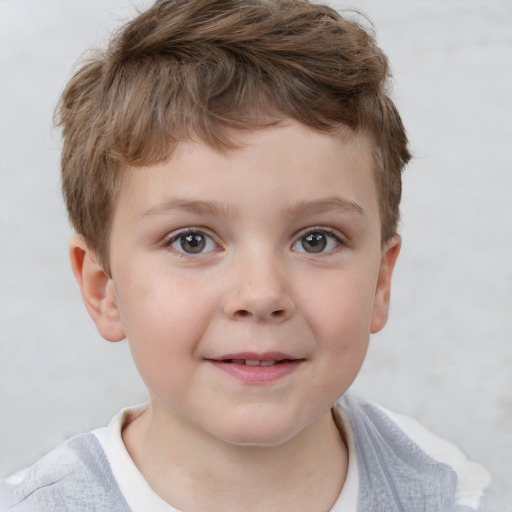 Joyful white child male with short  brown hair and grey eyes