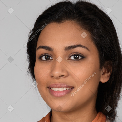 Joyful latino young-adult female with medium  brown hair and brown eyes