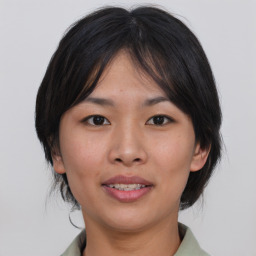 Joyful asian young-adult female with medium  brown hair and brown eyes