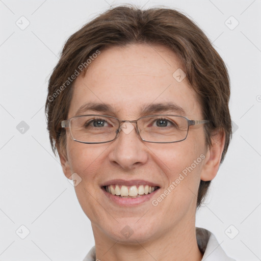 Joyful white adult female with short  brown hair and grey eyes