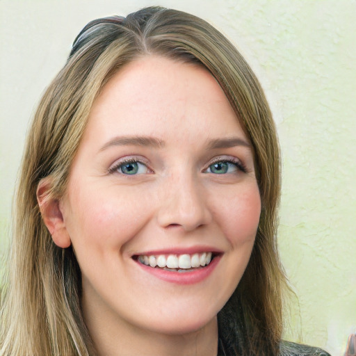 Joyful white young-adult female with long  brown hair and green eyes