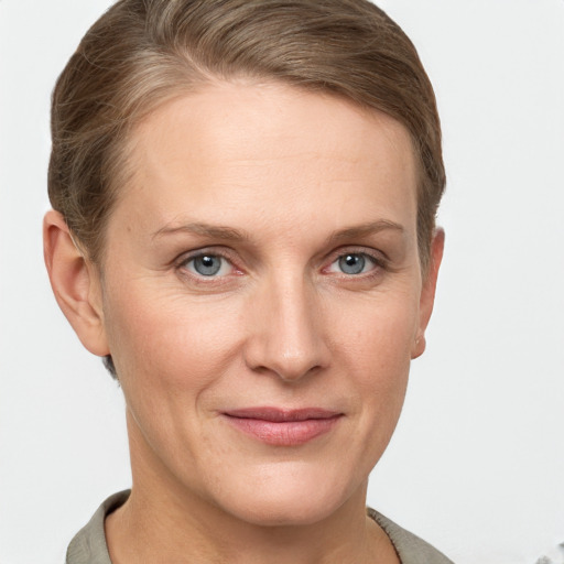 Joyful white adult female with short  brown hair and grey eyes