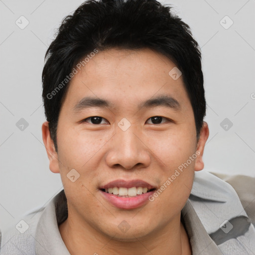 Joyful asian young-adult male with short  black hair and brown eyes