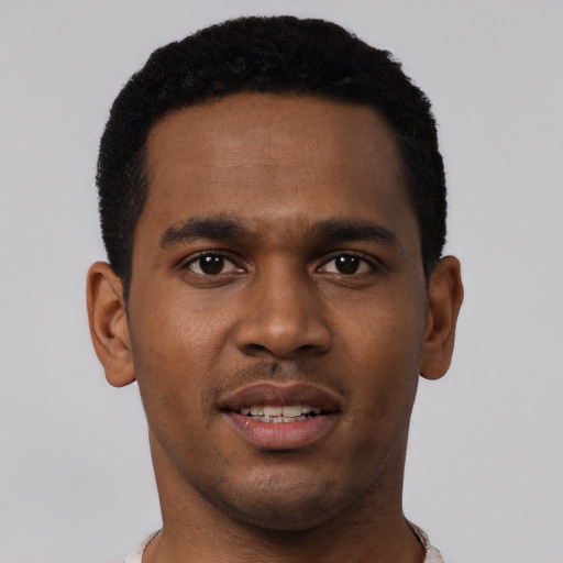 Joyful black young-adult male with short  black hair and brown eyes