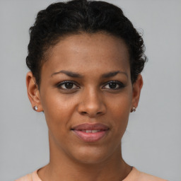 Joyful black young-adult female with short  brown hair and brown eyes